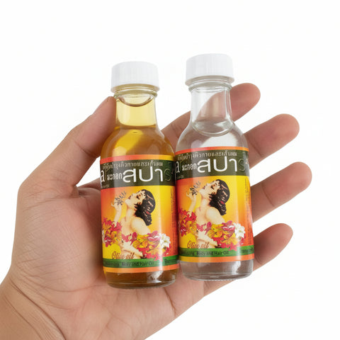 Two bottles of a product with colorful labels held by a hand, with more bottles in the background.